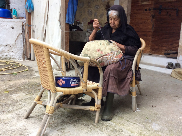 Andrigoni sewing in her porch