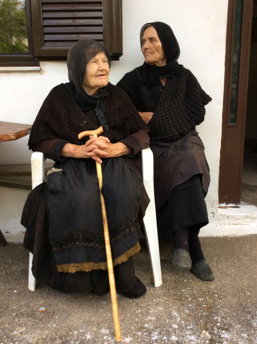 Calliope and visitor who wears old hand embroidered apron.