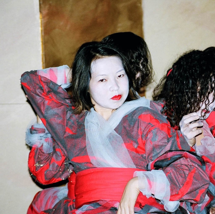 Sotoba Komachi: Jacket: Red & Grey layered cloth. Skirt: Red fine rubber, Cloth & decorated with recycled plastics.