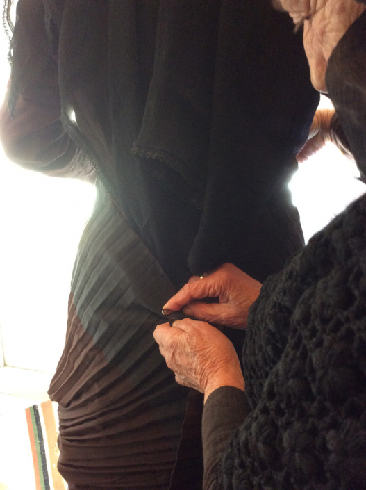 Lu Firth being dressed in traditional Lefkadian ‘Uniform’ by Theresa