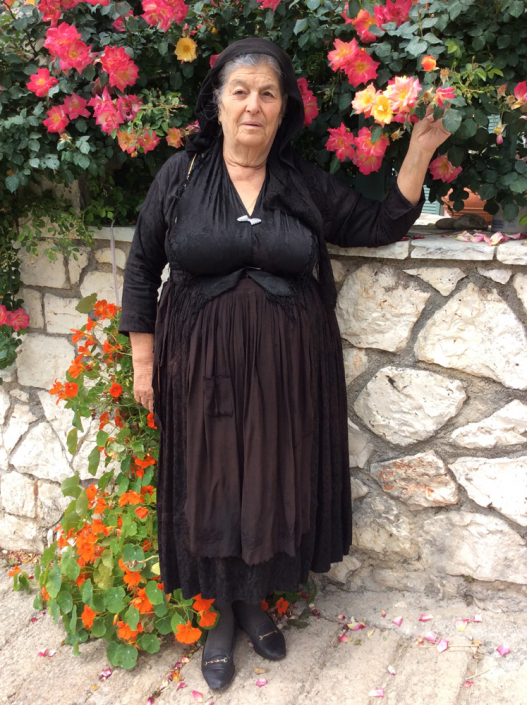 Maria dressed in traditional dress and silk shawl pinned centre front